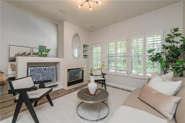 5 Bretagne, Newport Coast, CA 92657 - living room featuring a fireplace with flush hearth and light wood-style flooring