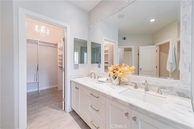 5 Bretagne, Newport Coast, CA 92657 - full bath featuring double vanity, wood finished floors, a spacious closet, and a chandelier