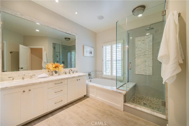 5 Bretagne, Newport Coast, CA 92657 - full bathroom featuring a stall shower, a garden tub, double vanity, wood finished floors, and recessed lighting