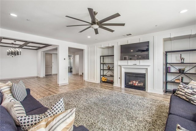 13438 Ambrosia Ct, Riverside, CA 92503 - living area with wood finished floors, ceiling fan, a glass covered fireplace, a chandelier, and recessed lighting
