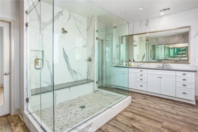 13438 Ambrosia Ct, Riverside, CA 92503 - bathroom with a marble finish shower, double vanity, and wood finished floors