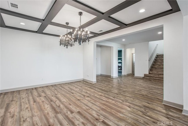 13438 Ambrosia Ct, Riverside, CA 92503 - unfurnished room with coffered ceiling, wood finished floors, a chandelier, stairway, and beam ceiling