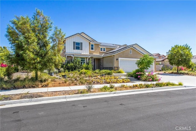13438 Ambrosia Ct, Riverside, CA 92503 - view of front of house featuring solar panels, an attached garage, driveway, and board and batten siding