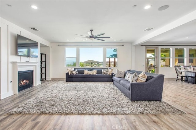 13438 Ambrosia Ct, Riverside, CA 92503 - living room with wood finished floors, a glass covered fireplace, a ceiling fan, and recessed lighting
