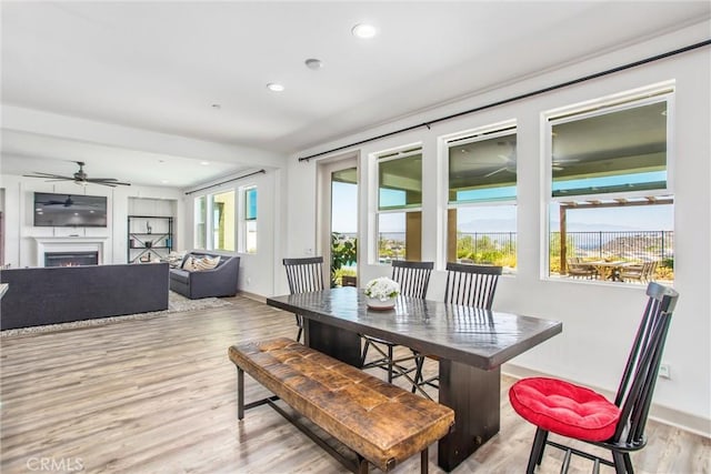 13438 Ambrosia Ct, Riverside, CA 92503 - dining space featuring light wood-type flooring, a ceiling fan, recessed lighting, and a lit fireplace