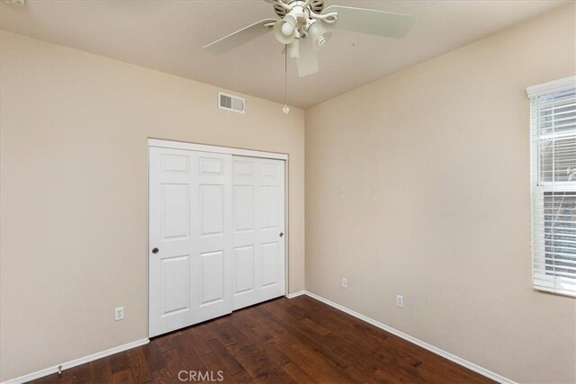31578 Waterfall Way, Murrieta, CA 92563 - unfurnished bedroom with dark wood-style floors, ceiling fan, and a closet