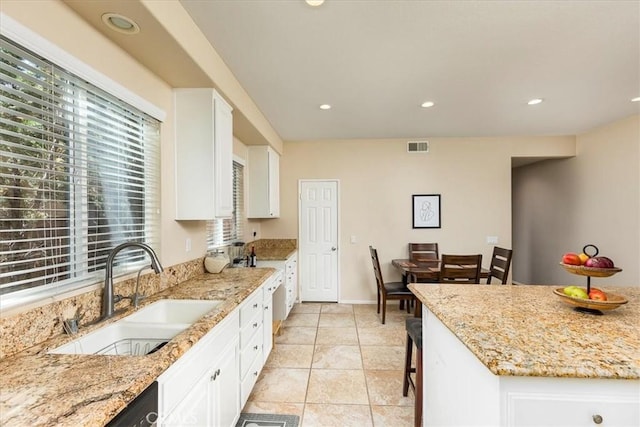 31578 Waterfall Way, Murrieta, CA 92563 - kitchen with white cabinets, light stone countertops, recessed lighting, and a breakfast bar