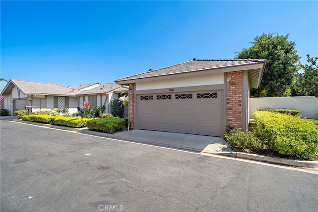 1061 Regis Way, Tustin, CA 92780 - ranch-style house featuring brick siding, stucco siding, and a garage