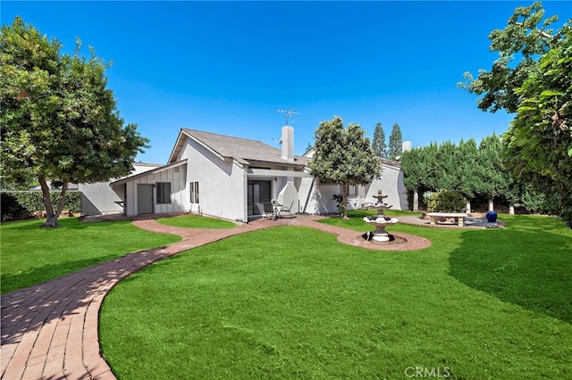 1061 Regis Way, Tustin, CA 92780 - back of property with a yard, a patio, and a chimney