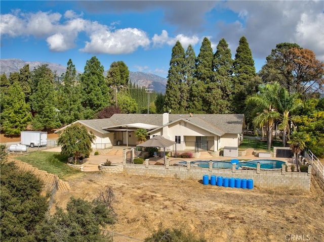 43350 Dunlap, Banning, CA 92220 - back of property featuring a patio area, a mountain view, and a chimney
