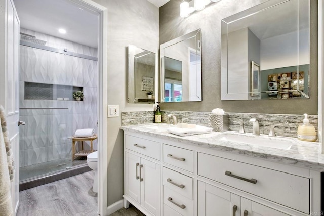 12395 Filera Rd, San Diego, CA 92128 - bathroom with double vanity, wood finished floors, and tiled shower