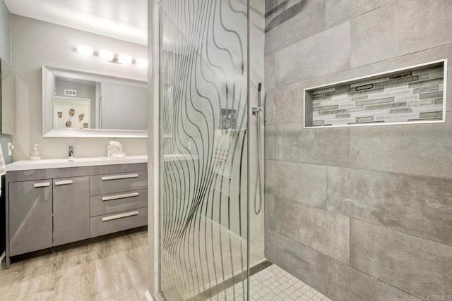 12395 Filera Rd, San Diego, CA 92128 - full bathroom featuring a shower stall, vanity, and wood finished floors