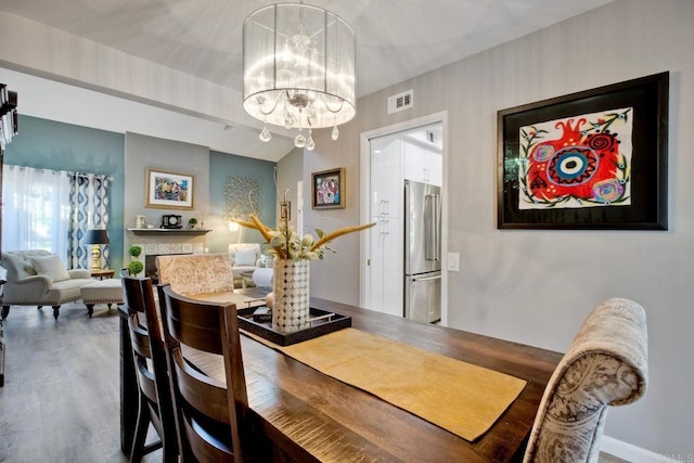 12395 Filera Rd, San Diego, CA 92128 - dining room with a chandelier and wood finished floors