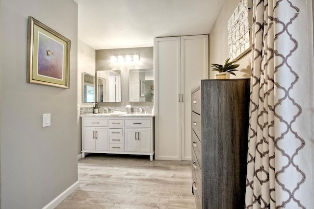 12395 Filera Rd, San Diego, CA 92128 - full bathroom featuring double vanity and wood finished floors