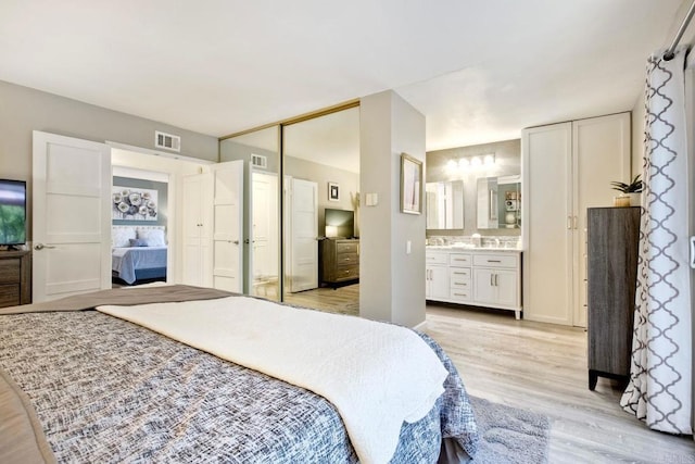 12395 Filera Rd, San Diego, CA 92128 - bedroom with light wood finished floors and connected bathroom