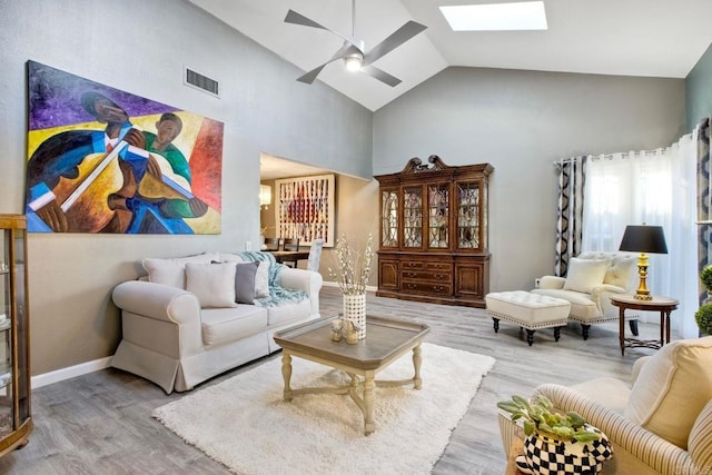 12395 Filera Rd, San Diego, CA 92128 - living area with ceiling fan, wood finished floors, a skylight, and high vaulted ceiling