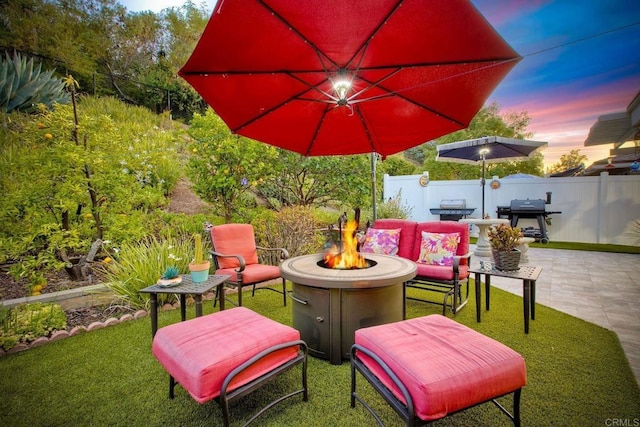 12395 Filera Rd, San Diego, CA 92128 - patio terrace at dusk featuring an outdoor fire pit, grilling area, and a patio
