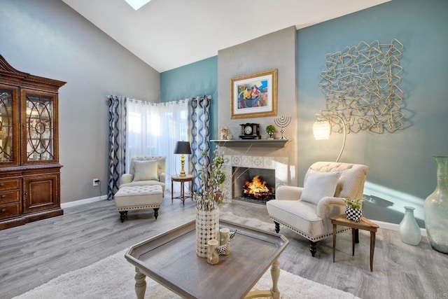 12395 Filera Rd, San Diego, CA 92128 - sitting room with wood finished floors, a lit fireplace, and high vaulted ceiling