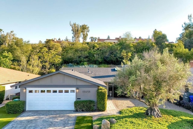 12395 Filera Rd, San Diego, CA 92128 - view of front of house featuring an attached garage, board and batten siding, and decorative driveway