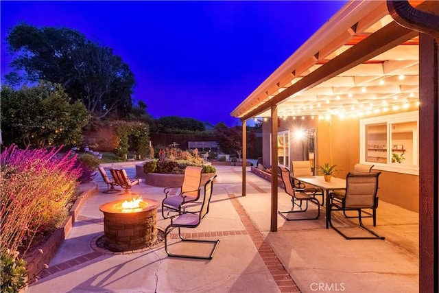 4368 Manchester Ct, Santa Maria, CA 93455 - patio at night with an outdoor fire pit, a patio area, and outdoor dining area