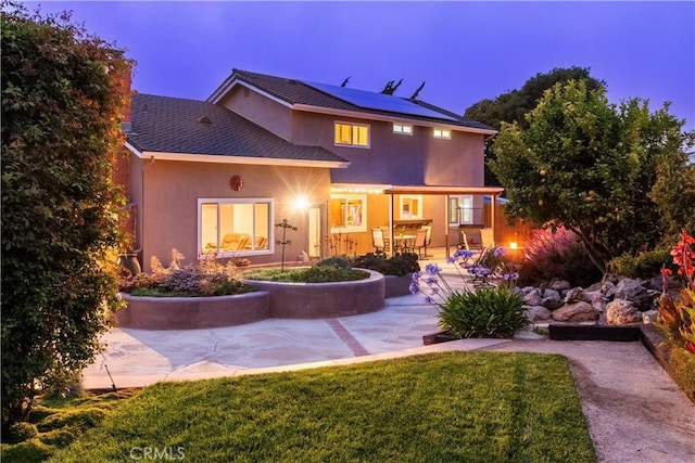 4368 Manchester Ct, Santa Maria, CA 93455 - rear view of house featuring roof mounted solar panels, stucco siding, a patio area, and a yard