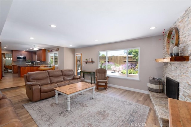 4368 Manchester Ct, Santa Maria, CA 93455 - living area with healthy amount of natural light, recessed lighting, light wood-style floors, a stone fireplace, and ceiling fan