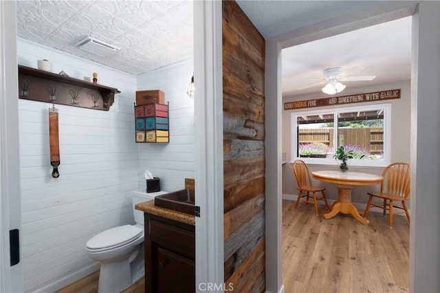 4368 Manchester Ct, Santa Maria, CA 93455 - bathroom with wood finished floors, ceiling fan, wooden walls, and vanity