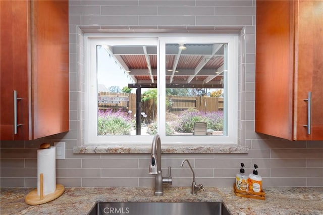 4368 Manchester Ct, Santa Maria, CA 93455 - kitchen with backsplash, brown cabinets, and light stone counters