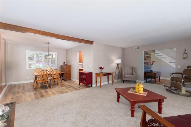 4368 Manchester Ct, Santa Maria, CA 93455 - living area with stairs, a chandelier, carpet floors, wood finished floors, and beamed ceiling