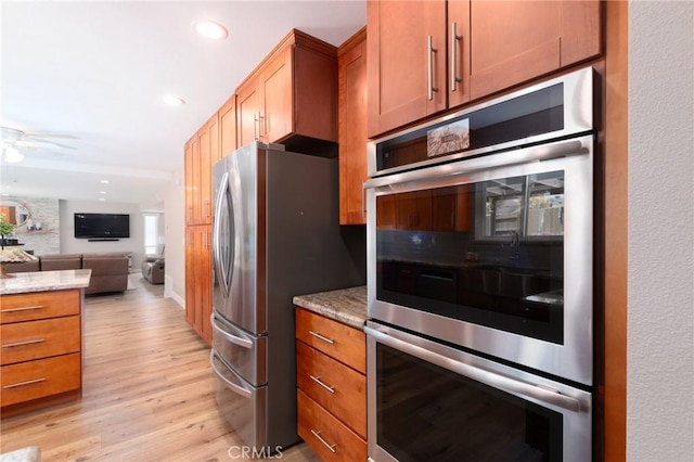 4368 Manchester Ct, Santa Maria, CA 93455 - kitchen with appliances with stainless steel finishes, open floor plan, ceiling fan, light wood-type flooring, and light stone countertops
