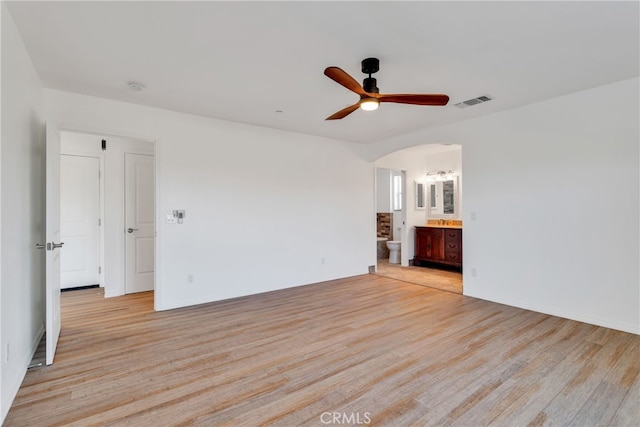 7765 Elwood St, Joshua Tree, CA 92252 - unfurnished room with light wood-type flooring, arched walkways, and ceiling fan