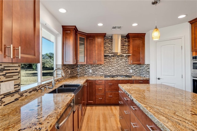7765 Elwood St, Joshua Tree, CA 92252 - kitchen featuring wall chimney exhaust hood, light stone countertops, stainless steel appliances, hanging light fixtures, and tasteful backsplash