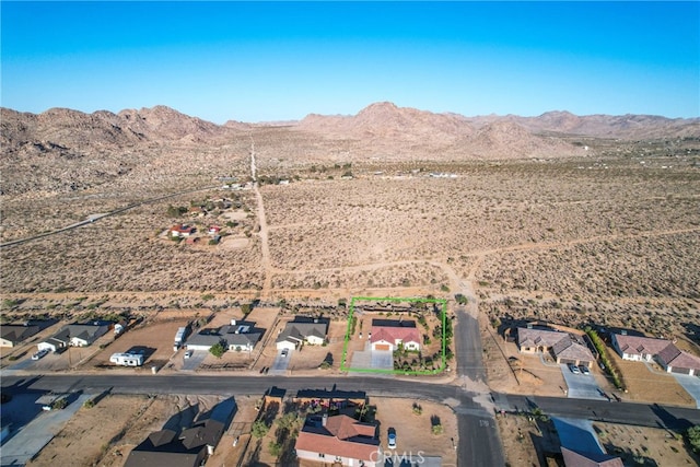 7765 Elwood St, Joshua Tree, CA 92252 - aerial overview of property's location with a mountainous background and rural landscape