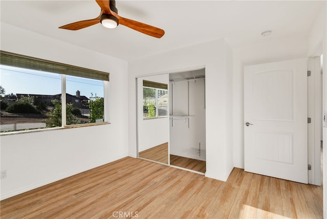 7765 Elwood St, Joshua Tree, CA 92252 - unfurnished bedroom with light wood-style floors, a closet, and a ceiling fan