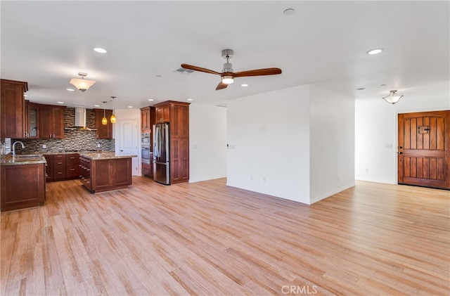 7765 Elwood St, Joshua Tree, CA 92252 - kitchen featuring stainless steel appliances, wall chimney range hood, recessed lighting, open floor plan, and a center island