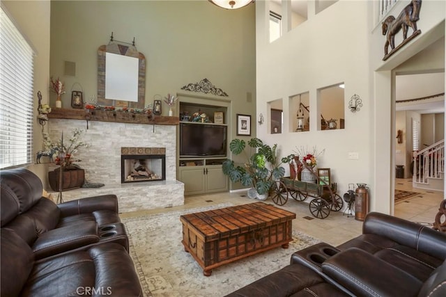 22760 Shadygrove Ct, Wildomar, CA 92595 - living room featuring a high ceiling, a stone fireplace, tile patterned floors, and stairs