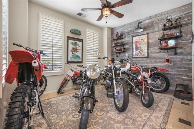 22760 Shadygrove Ct, Wildomar, CA 92595 - game room with an accent wall, a ceiling fan, wood walls, and tile patterned floors