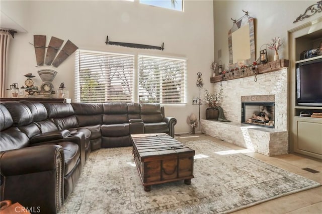 22760 Shadygrove Ct, Wildomar, CA 92595 - living room with healthy amount of natural light, a stone fireplace, tile patterned floors, and a high ceiling