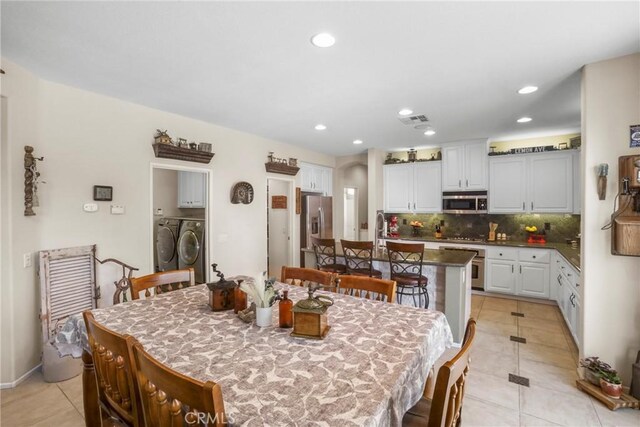 22760 Shadygrove Ct, Wildomar, CA 92595 - dining space with separate washer and dryer, light tile patterned flooring, and recessed lighting