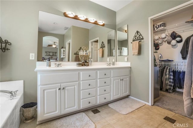 22760 Shadygrove Ct, Wildomar, CA 92595 - full bath with double vanity, tile patterned floors, ceiling fan, a garden tub, and a walk in closet