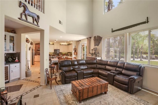 22760 Shadygrove Ct, Wildomar, CA 92595 - living room featuring plenty of natural light, light tile patterned floors, wine cooler, and a towering ceiling