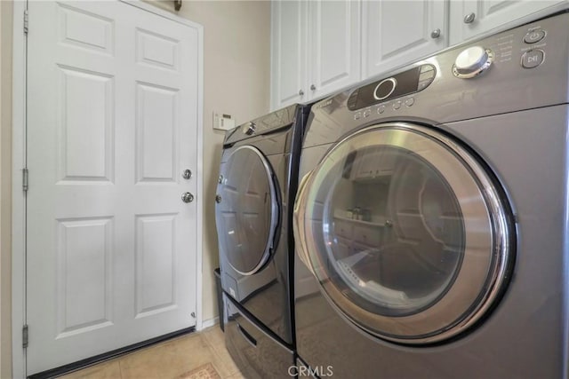 22760 Shadygrove Ct, Wildomar, CA 92595 - washroom with separate washer and dryer, cabinet space, and light tile patterned floors