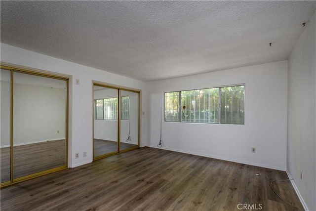 1032 S Golden W Ave Unit A, Arcadia, CA 91007 - unfurnished bedroom featuring multiple closets, wood finished floors, and a textured ceiling