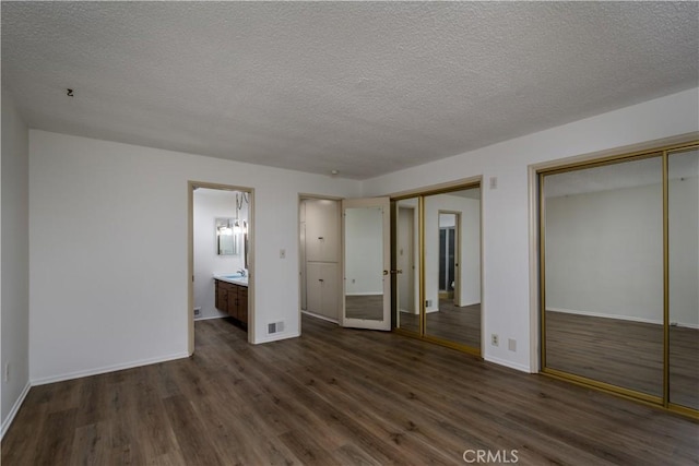 1032 S Golden W Ave Unit A, Arcadia, CA 91007 - unfurnished bedroom with multiple closets, dark wood-style flooring, a textured ceiling, and connected bathroom