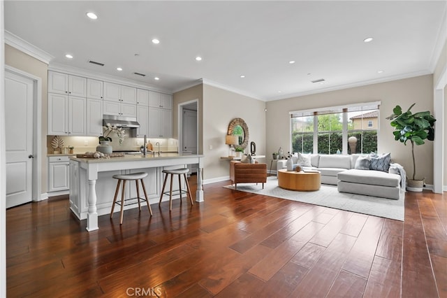 54 Sycamore Bnd, Irvine, CA 92620 - living area featuring dark wood-type flooring, recessed lighting, and ornamental molding