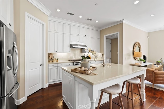 54 Sycamore Bnd, Irvine, CA 92620 - kitchen with stainless steel fridge, dark wood finished floors, ornamental molding, white cabinets, and a kitchen bar