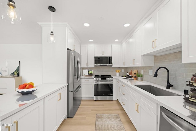 5300 E Atherton St Unit 2F, Long Beach, CA 90815 - kitchen with stainless steel appliances, white cabinetry, backsplash, light wood-type flooring, and pendant lighting