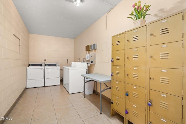 5300 E Atherton St Unit 2F, Long Beach, CA 90815 - shared laundry featuring washing machine and clothes dryer, tile walls, light tile patterned floors, and concrete block wall