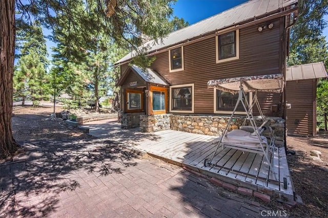 25837 Sunset Loop, Twin Peaks, CA 92391 - back of property with a metal roof, stone siding, and a deck
