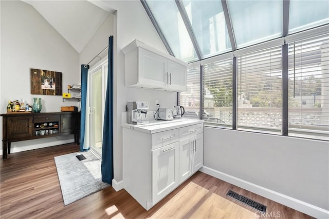 222 N Singingwood St Unit 9, Orange, CA 92869 - bar with vaulted ceiling and light wood-style flooring
